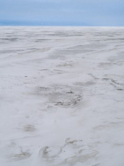 Ice landscape, endless panorama of the ice surface on the frozen river