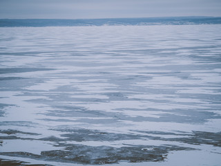Ice landscape, endless panorama of the ice surface on the frozen river