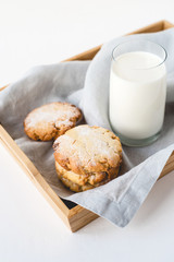Stacked cookies on a linen napkin and a glass of milk. Close up.