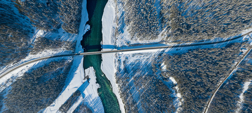 Panoramic aerial view nature and picturesque landscape near a Altay mountain with a green river Katun and bridge on a winter sunny day with blue sky - Powered by Adobe