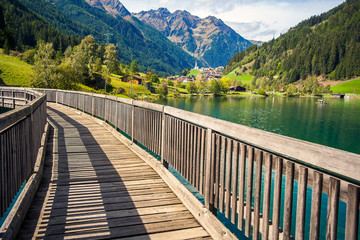 Naklejka premium Wooden bridge over the Mühlwald reservoir in Mühlwald South Tyrol Italy