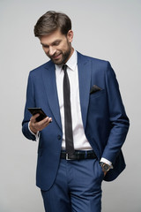 businessman talking on the phone isolated over grey background