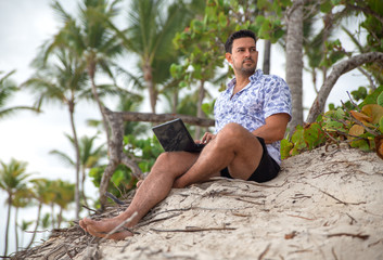 Successful freelancer businessman with laptop on the beach