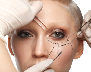 close up portrait of young white woman with perforation lines on face and hands in gloves with...