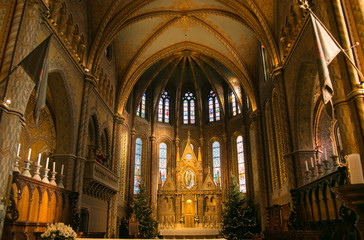 Beautiful interior of Matthias church with two christmas trees in the castle district of Budapest, Hungary
