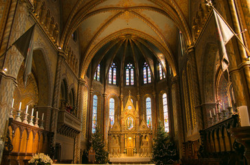 Beautiful interior of Matthias church with two christmas trees in the castle district of Budapest,...