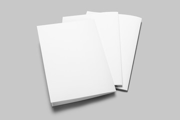 Three blank white folded papers mockup template on gray background