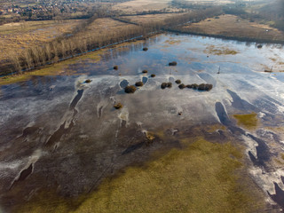 Aerial winter landscape over frozen pond