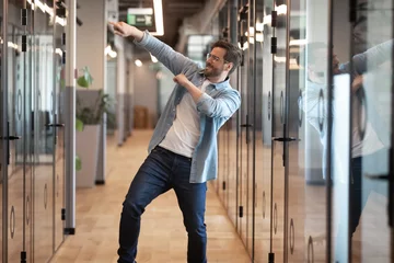  Funny happy male employee dance in office celebrating © fizkes