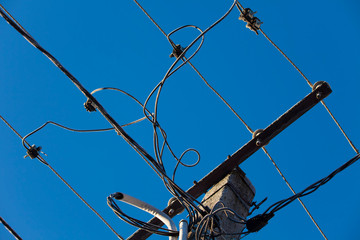 details of wires of electricity on pole. blue sky background