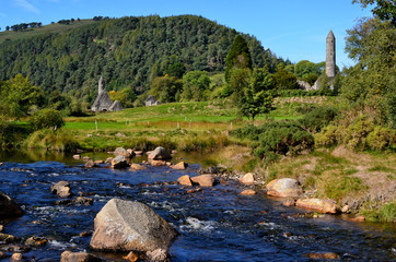 landscape with river and celtic round tower Glendalough