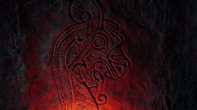 Norse Dragon Stone Carving Illuminated With Fire