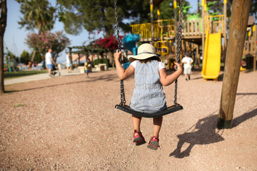 Sad depressed child lonely sways near playground