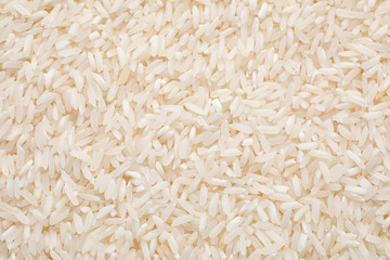 Pile of polished rice as background, top view
