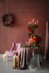 Table decorated with artificial fruits and candles.