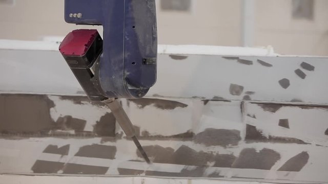 Industry Robot carwer machine - back view- carwing out fiber glass - boat factory