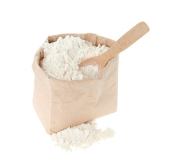 Organic flour and spoon in paper bag isolated on white