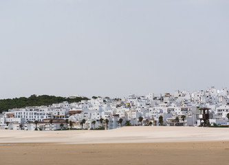 Panoramic view from beach to Andalusian town Conil de la Frontera, Cadiz province, Costa de la Luz, Spain © annatcelykh