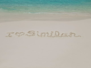 view of Similan Text on white sand beach with blue-green sea background, Similan island, Mu Ko Similan National Park, Phang Nga, southern of Thailand.