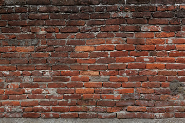 Dark red brick wall old and weathered