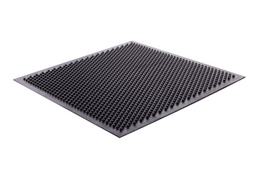 Black rubber entrance mat isolated on white background. Cellular rubber mat for dirt removal. Welcome carpet, close up