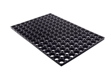 Black rubber entrance mat isolated on white background. Cellular rubber mat for dirt removal....