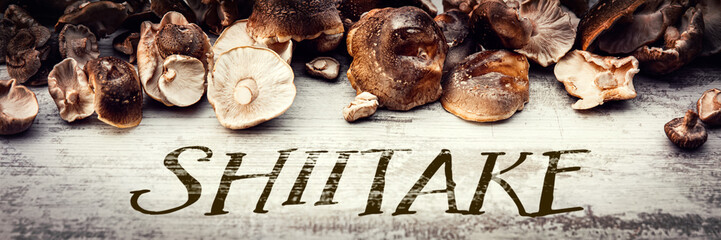 Shiitake mushrooms on wooden table, Lentinula edodes header