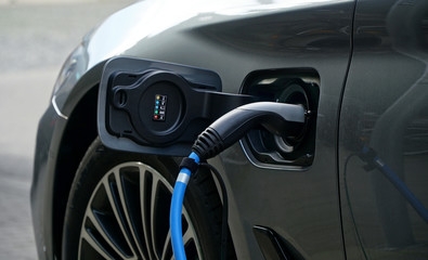 Electric or hybrid car refueling electricity at a charging station            