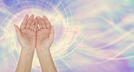 I am a channel for healing energy -  female open palm hands against a multicoloured spiralling...