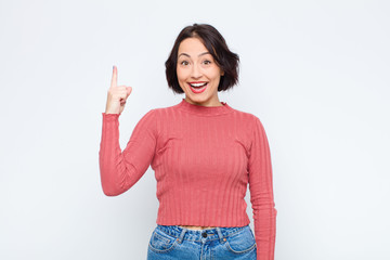 young pretty woman feeling like a happy and excited genius after realizing an idea, cheerfully...