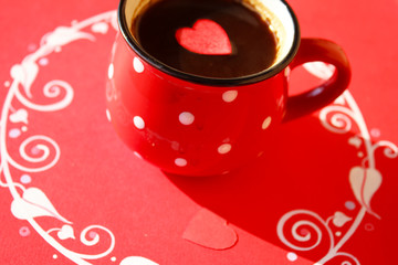 A couple off black coffe with red paper heart on red devorated background, valentine day