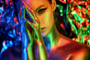 High fashion model girl portrait with colorful powder make up. Beauty woman with bright color...