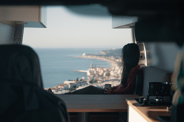 Woman sitting in vehicle looking at view