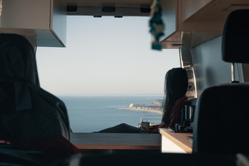 Woman sitting in vehicle looking at view