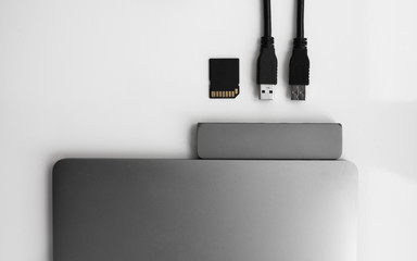 Laptop with USB Type-C adapter with pluged USB cables and SD card. The USB adapter under the Type-C...