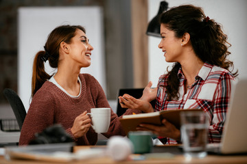 Two women working together.  Beautiful colleagues working on project. 
