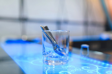 glass with spooins in ultraviolet light