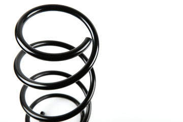 black car spring on a white background with copy space. car parts backdrop