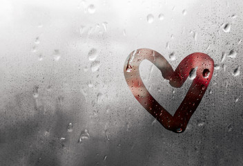 Red heart painted on glass is fogged up and there are many drops on it, Valentine's Day concept, banner with copy space,