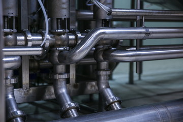 industrial background of steel pipeline in a food factory close up