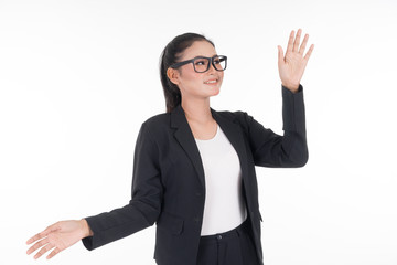 An attractive woman wearing business attire waving her hands in the air navigating on an invisible screen isolated on white. Suitable for image cut out and manipulation works for technology, business.