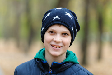 Portrait of a teenage boy in a park, autumn, october, emotions, happy, smiles