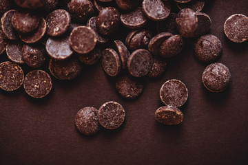 milk chocolate pieces preform candies in daylight for background