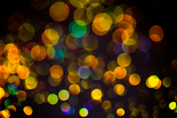 Multicolor glitter raster background. Abstract shimmering red circles on deep purple backdrop. Vibrant bokeh lights effect festive illustration. Overlapping glowing and twinkling spots.