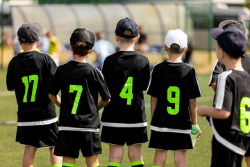 Kids Soccer Team Waiting On The Bench