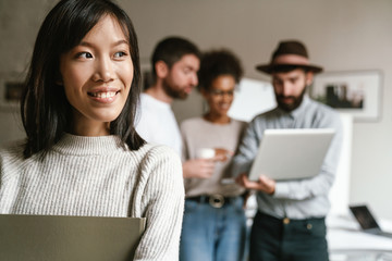 Image of multiethnic young business people working together at office
