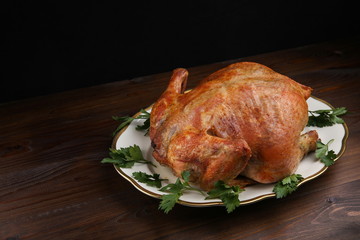 roasted chicken with greens on dark wooden background with copy space