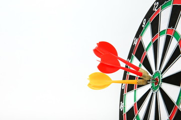 darts on white background with copy space. three darts hit the target