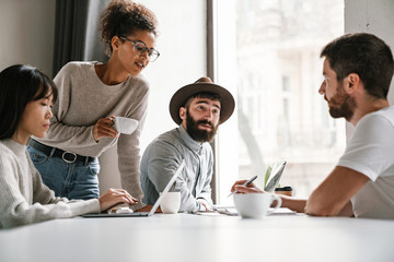Image of multiethnic young business people working together at office