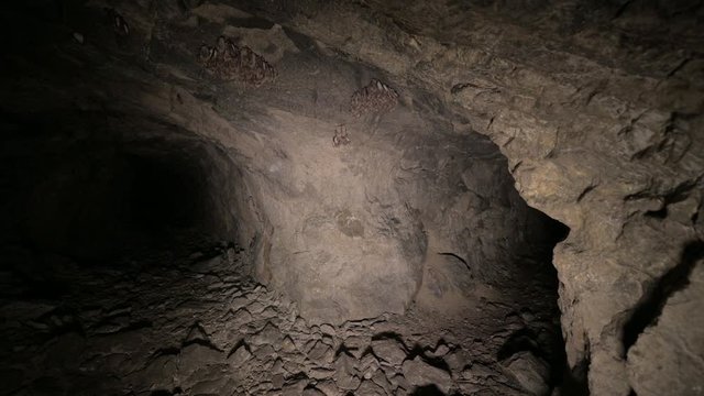 Speleology artificial cave dark tunnel excavation underground. Old adit for the extraction of metal and rocks